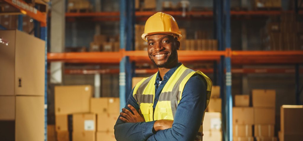 An image of a man wearing a hard hat and hi-vis jacket.