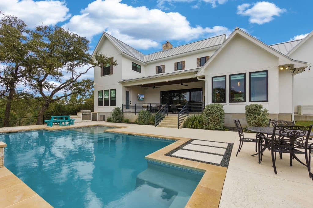 An image of a large house with swimming pool.