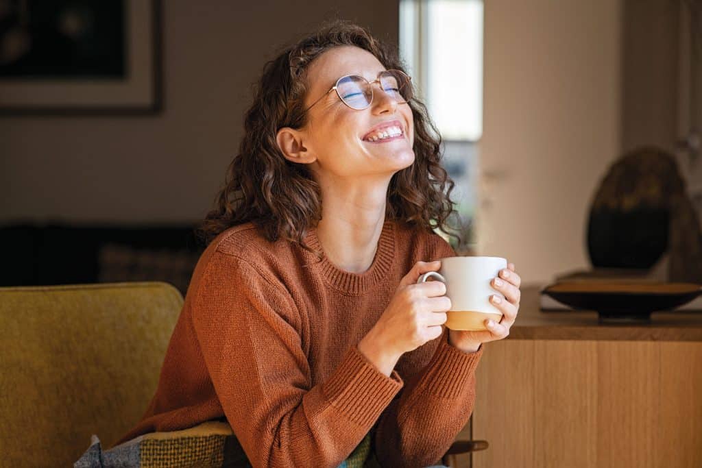 An image of a woman enjoying a cup of coffee.