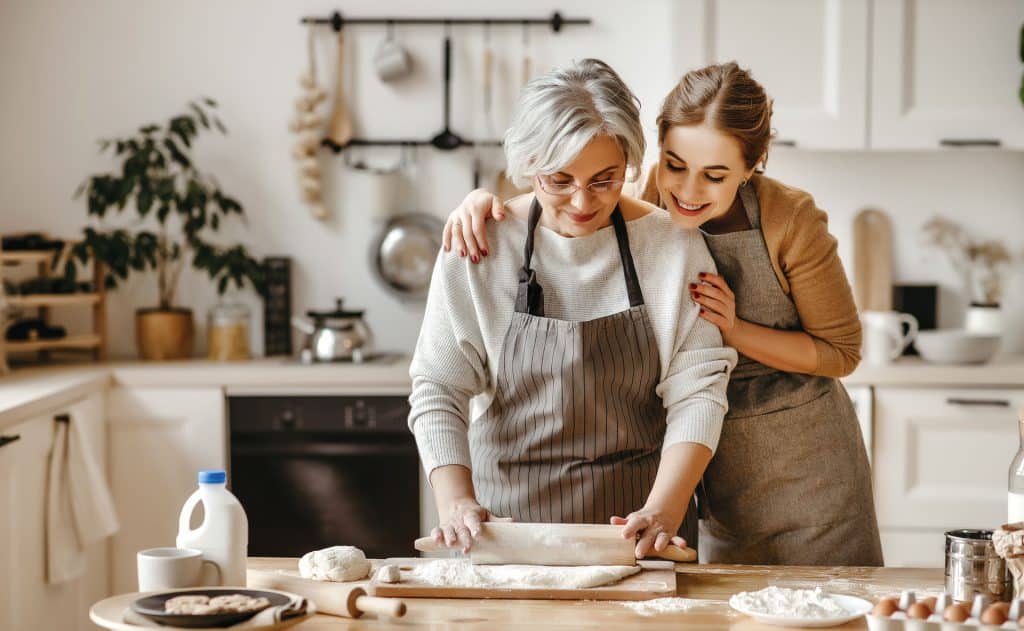 An image of a mother and daugher baking together.