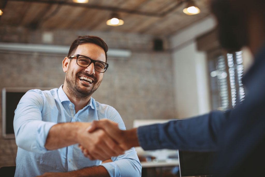 An image of two men shaking hands.